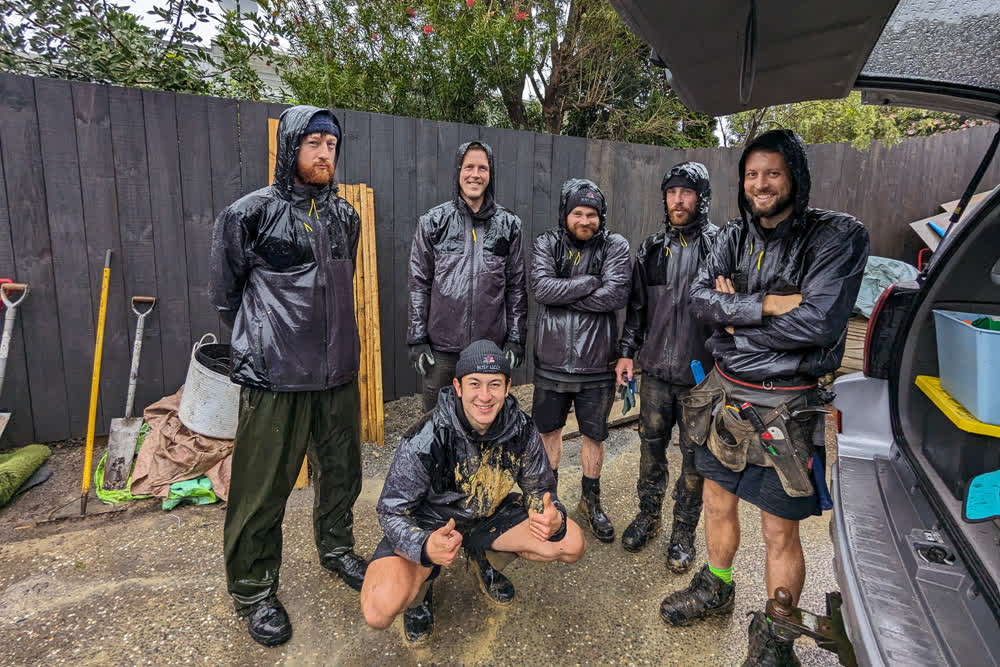 Team group shot in rain jackets after a job well done